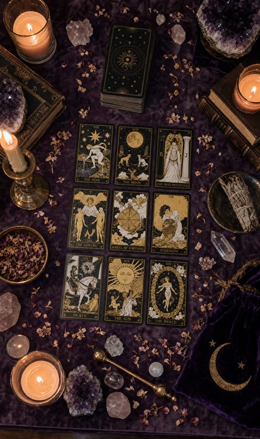 A full tarot spread laid out by candlelight for your reading